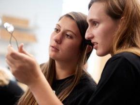 Two students look at experiment in a science lab