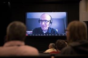 Chad Rimmer appears via Zoom on the large screen at Q&A session in Belk Centrum