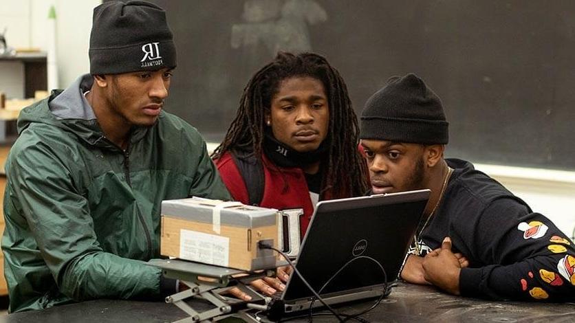 LR football players working in the engineering lab